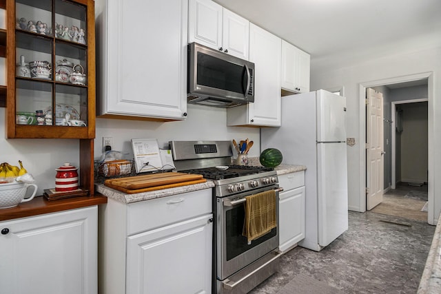 10158 US Highway 31, Berrien Springs, MI 49103 - kitchen featuring appliances with stainless steel finishes, white cabinets, and glass insert cabinets