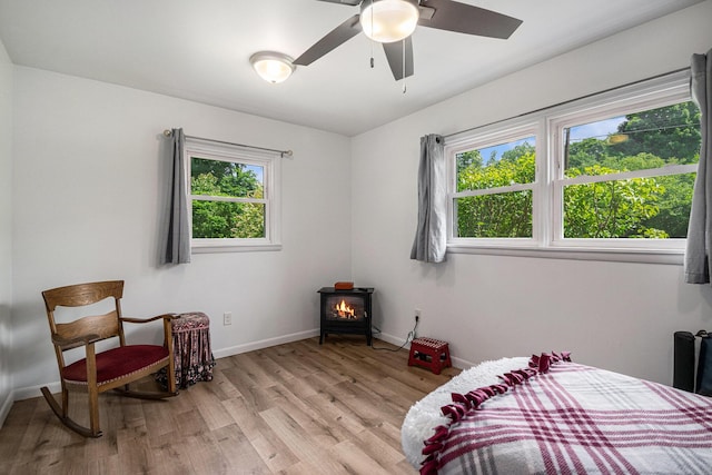 10158 US Highway 31, Berrien Springs, MI 49103 - bedroom featuring a wood stove and light wood-style flooring