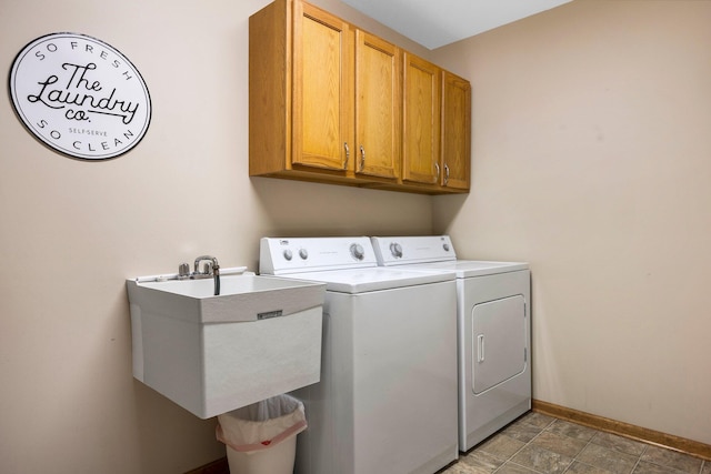 1724 N Ridge Rd, Mears, MI 49436 - laundry area featuring independent washer and dryer, cabinet space, and stone finish floors