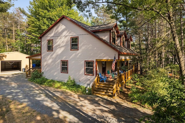 1724 N Ridge Rd, Mears, MI 49436 - view of front of property with an outdoor structure, covered porch, and a garage