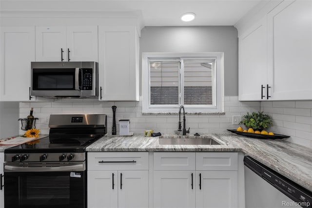 14671 Labelle St, Oak Park, MI 48237 - kitchen featuring stainless steel appliances, white cabinetry, tasteful backsplash, and light stone counters