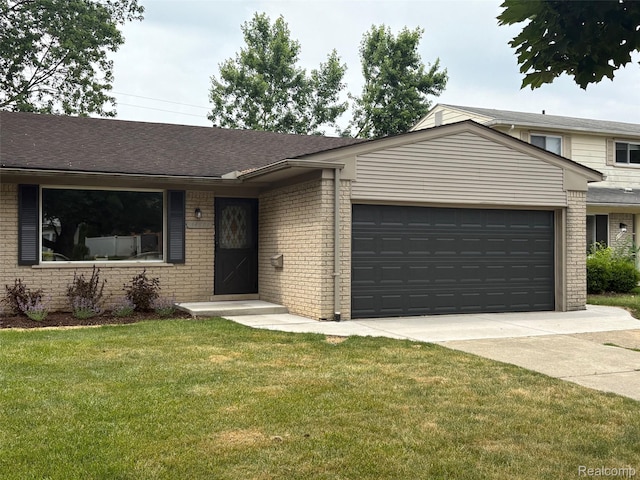 14671 Labelle St, Oak Park, MI 48237 - view of front of property featuring an attached garage, brick siding, concrete driveway, and a front yard