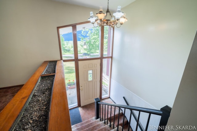 9546 Benham St NE, Cedar Springs, MI 49319 - entrance foyer featuring a chandelier, carpet flooring, and vaulted ceiling