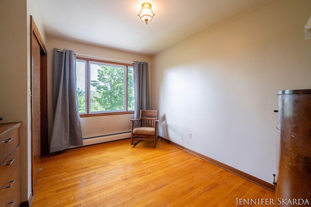 9546 Benham St NE, Cedar Springs, MI 49319 - living area with a baseboard heating unit, light wood-type flooring, and lofted ceiling