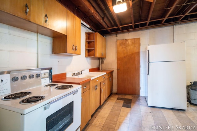 9546 Benham St NE, Cedar Springs, MI 49319 - kitchen with white appliances, light countertops, open shelves, brown cabinets, and concrete block wall