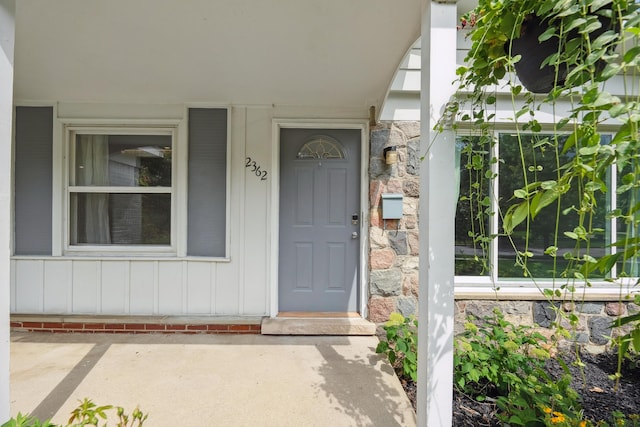 2362 Georgetown Blvd, Ann Arbor, MI 48105 - view of exterior entry featuring stone siding, a porch, and board and batten siding