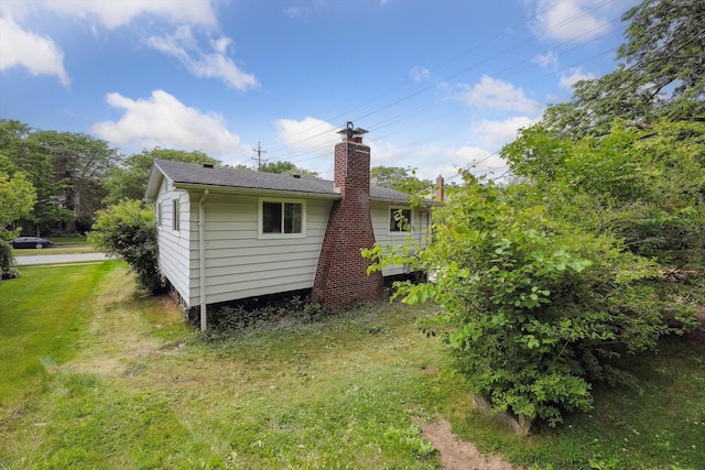 2362 Georgetown Blvd, Ann Arbor, MI 48105 - rear view of house featuring a lawn, a chimney, and roof with shingles