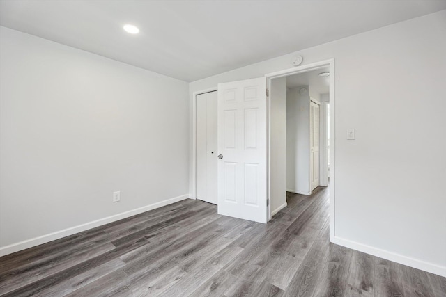 2362 Georgetown Blvd, Ann Arbor, MI 48105 - unfurnished bedroom with wood finished floors, a closet, and recessed lighting