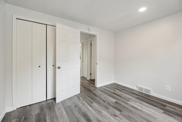 2362 Georgetown Blvd, Ann Arbor, MI 48105 - unfurnished bedroom with wood finished floors, recessed lighting, and a closet