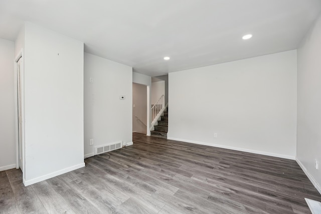 2362 Georgetown Blvd, Ann Arbor, MI 48105 - unfurnished room featuring recessed lighting, wood finished floors, and stairway