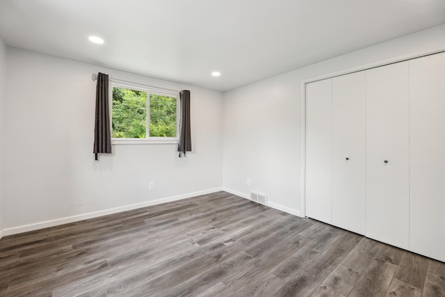2362 Georgetown Blvd, Ann Arbor, MI 48105 - unfurnished bedroom featuring wood finished floors, a closet, and recessed lighting