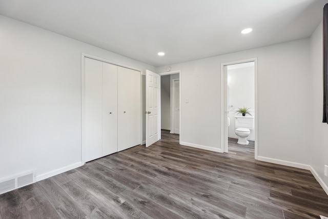 2362 Georgetown Blvd, Ann Arbor, MI 48105 - unfurnished bedroom featuring a closet, dark wood finished floors, recessed lighting, and ensuite bath