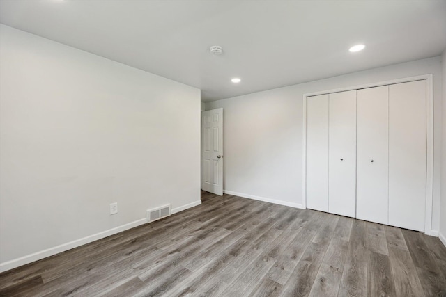 2362 Georgetown Blvd, Ann Arbor, MI 48105 - unfurnished bedroom with wood finished floors, recessed lighting, and a closet