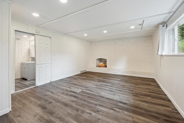 2362 Georgetown Blvd, Ann Arbor, MI 48105 - below grade area featuring a fireplace, wood finished floors, brick wall, and recessed lighting