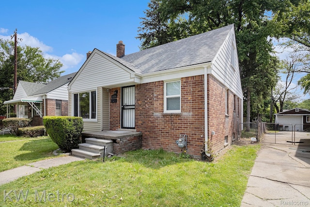 11416 Pierson St, Detroit, MI 48228 - view of front of home with brick siding, a chimney, a gate, a shingled roof, and a detached garage