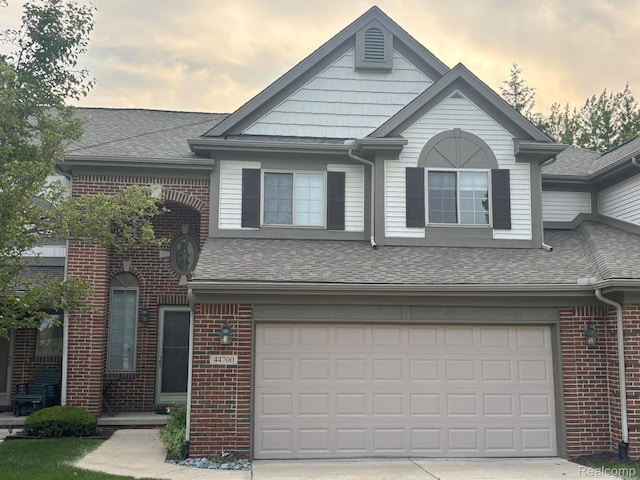 44700 Heather Ln, Canton, MI 48187 - view of front of home with roof with shingles, brick siding, and a garage