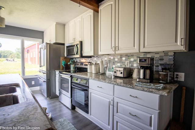 4295 S Gordon Ave, Fremont, MI 49412 - kitchen featuring stainless steel appliances, backsplash, wood finished floors, and white cabinetry
