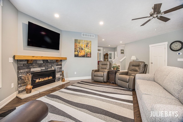 12828 Bayou Ct, Wayland, MI 49348 - living area featuring wood finished floors, a ceiling fan, a stone fireplace, and recessed lighting