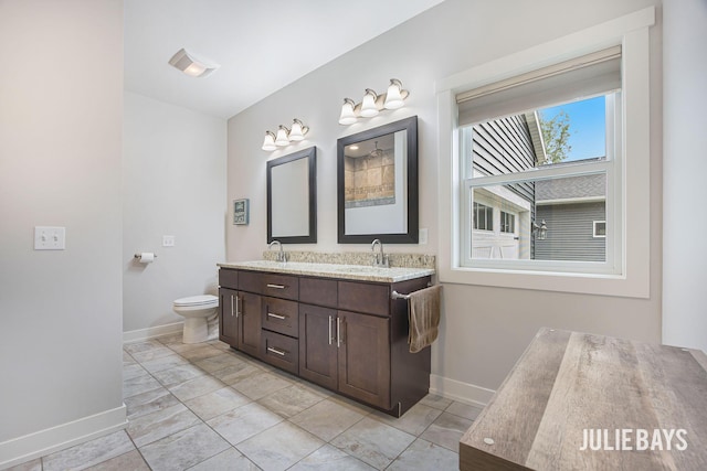 12828 Bayou Ct, Wayland, MI 49348 - bathroom with double vanity and baseboards
