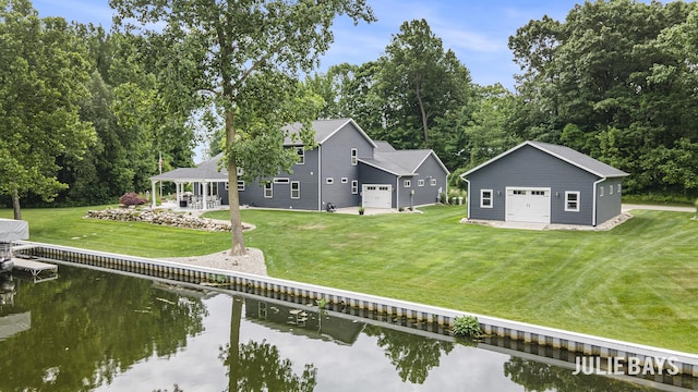 12828 Bayou Ct, Wayland, MI 49348 - rear view of property with a water view, a garage, a yard, an outdoor structure, and view of wooded area