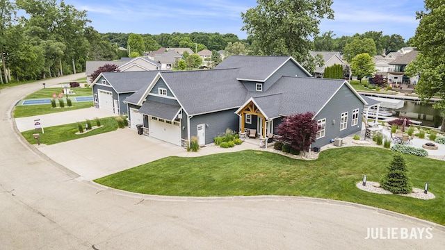 12828 Bayou Ct, Wayland, MI 49348 - view of front of house with driveway, roof with shingles, a front lawn, and a residential view