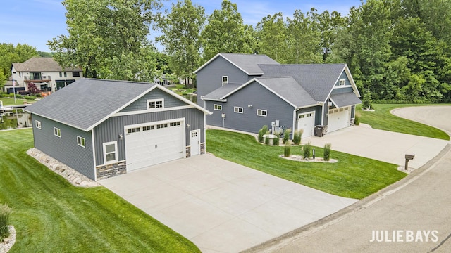 12828 Bayou Ct, Wayland, MI 49348 - craftsman house with a front lawn, concrete driveway, stone siding, and board and batten siding