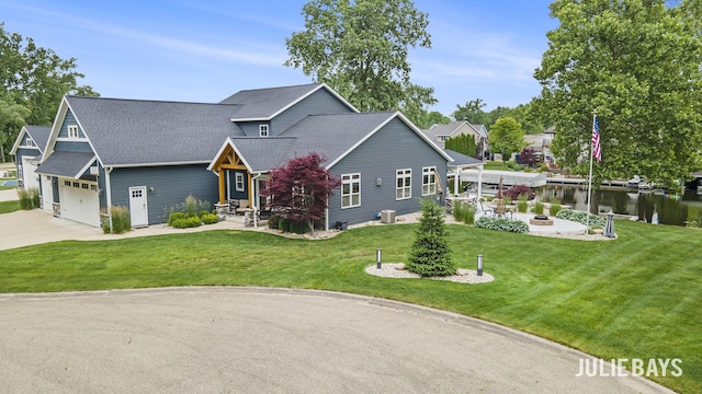 12828 Bayou Ct, Wayland, MI 49348 - view of front of home featuring an outdoor fire pit, driveway, a front yard, roof with shingles, and a garage