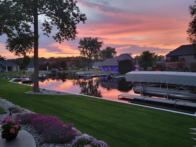 12828 Bayou Ct, Wayland, MI 49348 - view of green lawn with boat lift, a dock, and a water view