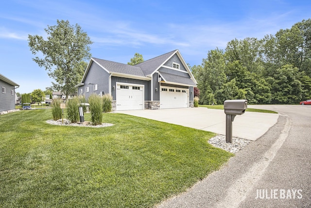 12828 Bayou Ct, Wayland, MI 49348 - view of side of home with board and batten siding, a lawn, driveway, an attached garage, and stone siding