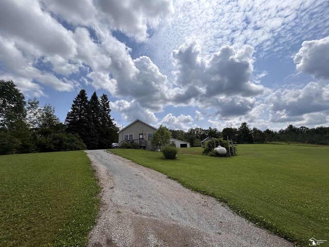 1645 N M-65 Rd, Curran, MI 48728 - ranch-style home featuring a front yard and gravel driveway