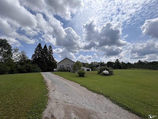 1645 N M-65 Rd, Curran, MI 48728 - ranch-style house with a front lawn and driveway