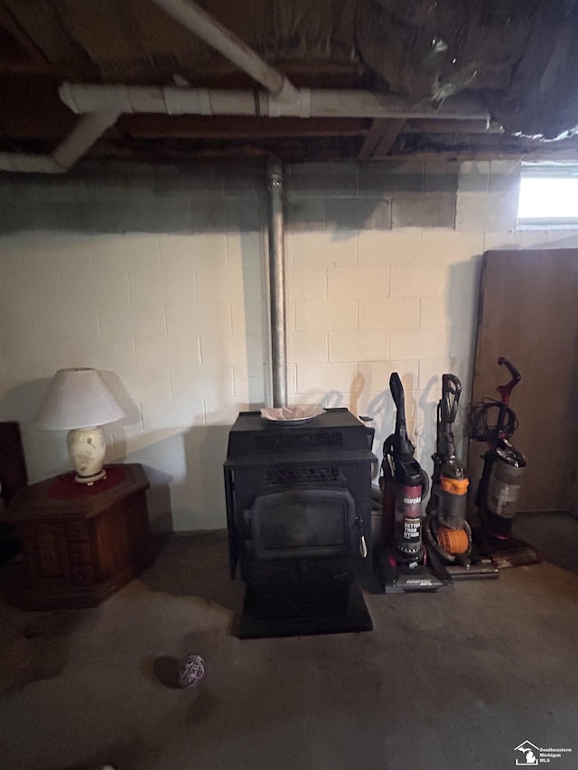 1645 N M-65 Rd, Curran, MI 48728 - basement with a wood stove