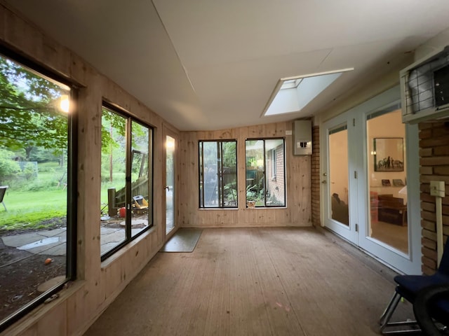 3431 Pineview Dr, Dexter, MI 48130 - unfurnished sunroom with a skylight, wood finished floors, french doors, plenty of natural light, and wooden walls