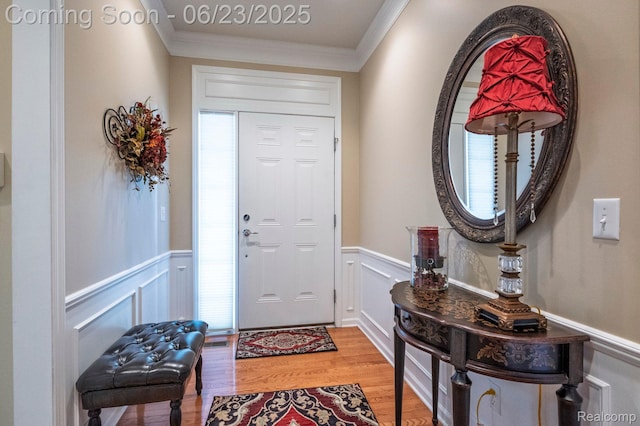 601 Acadia Ct, Howell, MI 48843 - foyer entrance with light wood-type flooring, wainscoting, crown molding, and a decorative wall