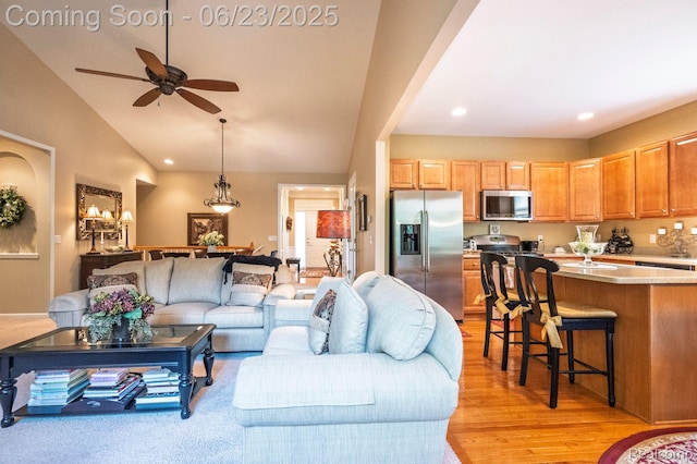 601 Acadia Ct, Howell, MI 48843 - living area with a ceiling fan, vaulted ceiling, light wood-style floors, and recessed lighting