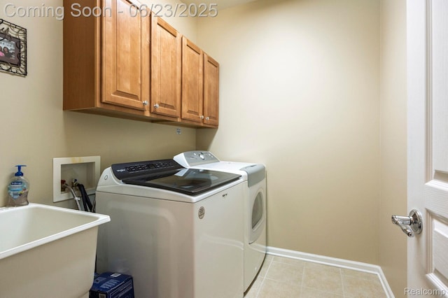601 Acadia Ct, Howell, MI 48843 - washroom with washing machine and clothes dryer, cabinet space, and light tile patterned flooring