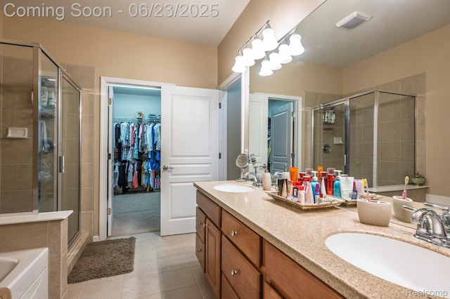 601 Acadia Ct, Howell, MI 48843 - full bathroom with a stall shower, double vanity, a spacious closet, and tile patterned floors