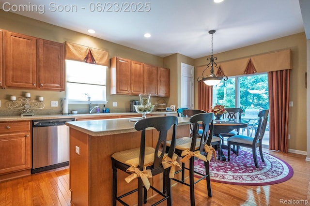 601 Acadia Ct, Howell, MI 48843 - kitchen featuring stainless steel dishwasher, light wood-style floors, decorative light fixtures, light countertops, and recessed lighting