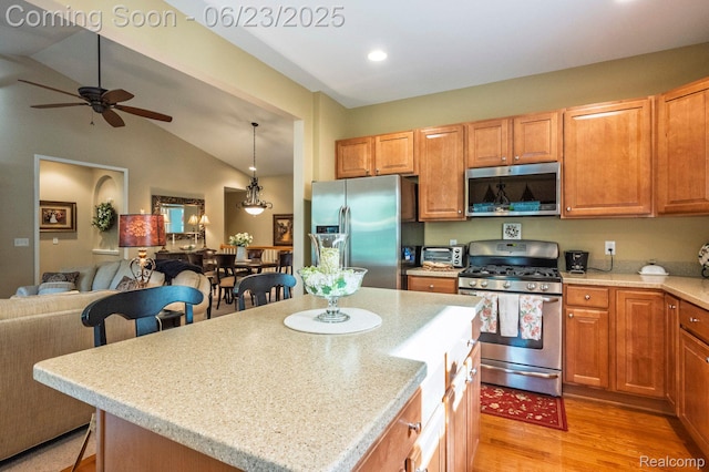601 Acadia Ct, Howell, MI 48843 - kitchen featuring appliances with stainless steel finishes, open floor plan, light wood-style floors, ceiling fan, and light countertops