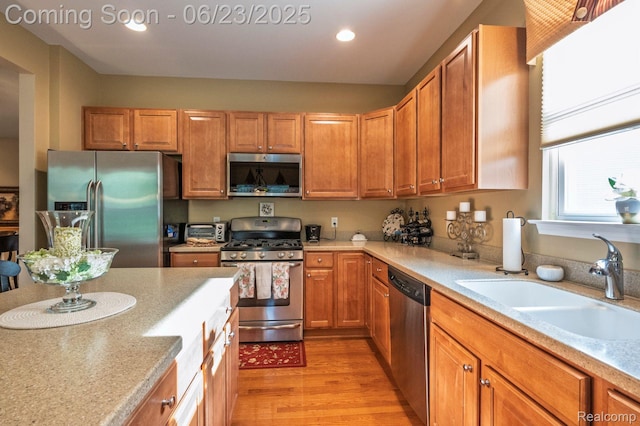 601 Acadia Ct, Howell, MI 48843 - kitchen with stainless steel appliances, light wood-style floors, light countertops, and recessed lighting