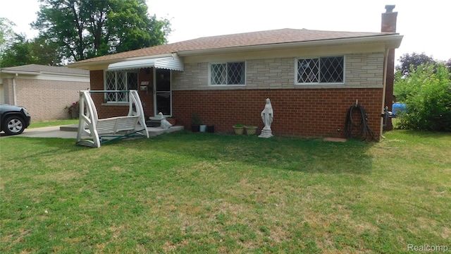 27038 Grobbel Dr, Warren, MI 48092 - view of front of house featuring a chimney, a front lawn, and brick siding