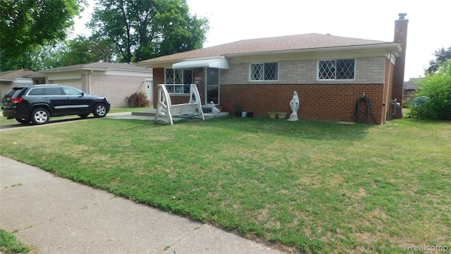 27038 Grobbel Dr, Warren, MI 48092 - view of front facade with brick siding, a front lawn, and a chimney