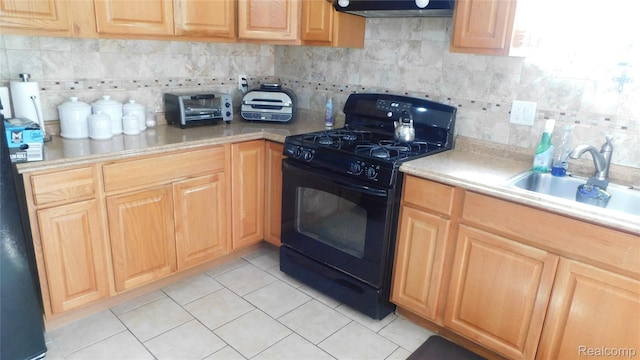 27038 Grobbel Dr, Warren, MI 48092 - kitchen with black gas range oven, decorative backsplash, exhaust hood, light tile patterned flooring, and light countertops