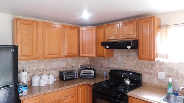 27038 Grobbel Dr, Warren, MI 48092 - kitchen with black appliances, under cabinet range hood, backsplash, and light countertops