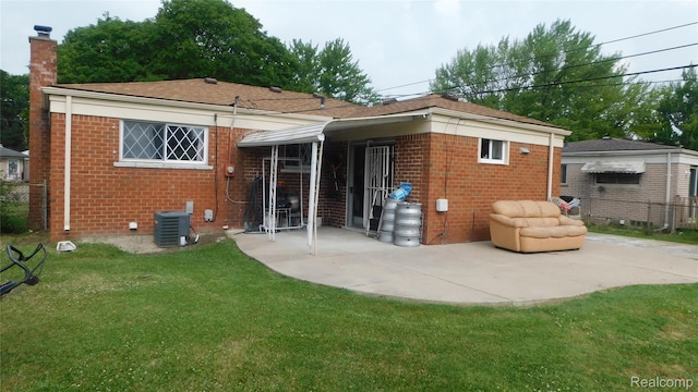 27038 Grobbel Dr, Warren, MI 48092 - back of property with brick siding, a patio area, and a chimney