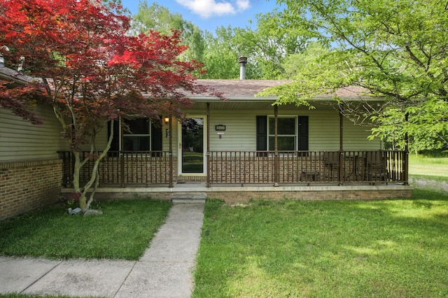 26434 King Rd, Romulus, MI 48174 - view of front of home with a porch, a front yard, and a shingled roof