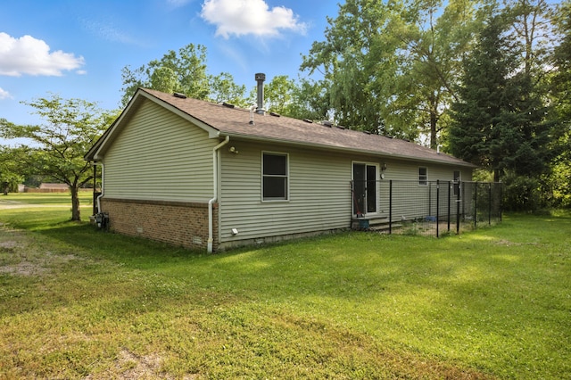 26434 King Rd, Romulus, MI 48174 - back of house with a yard, brick siding, and roof with shingles