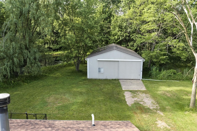 26434 King Rd, Romulus, MI 48174 - view of green lawn with an outdoor structure, an outbuilding, and a view of trees