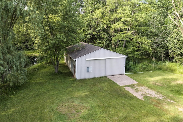 26434 King Rd, Romulus, MI 48174 - view of pole building featuring a lawn, a forest view, and driveway