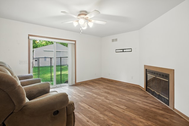 26434 King Rd, Romulus, MI 48174 - living area with a ceiling fan, wood finished floors, and a glass covered fireplace